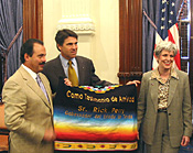 Perry receives a hand-made Mexican blanket from Governor Enrique Martinez of Coahuila, Mexico.