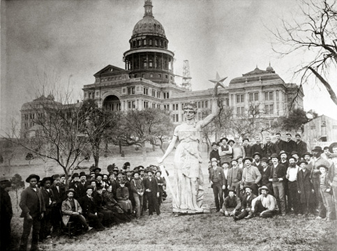 Photo of crowd with the Goddess of Liberty statue before it was placed atop the capitol dome.